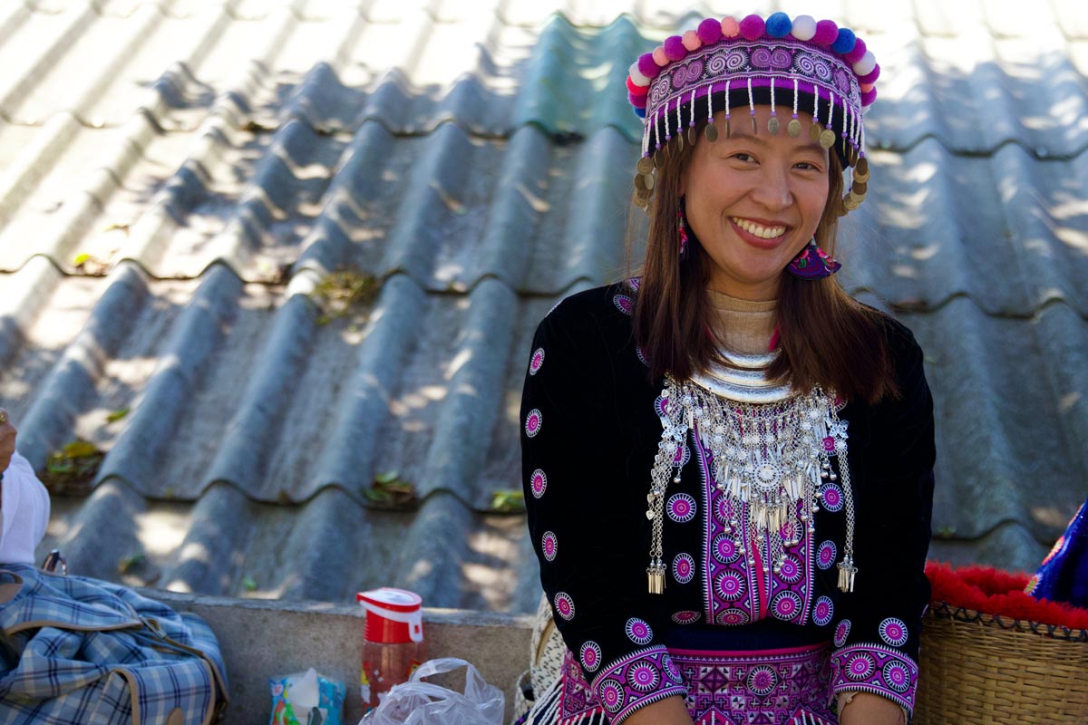 Asia Thailand smiling woman wearing cultural dress, jewelry and hat